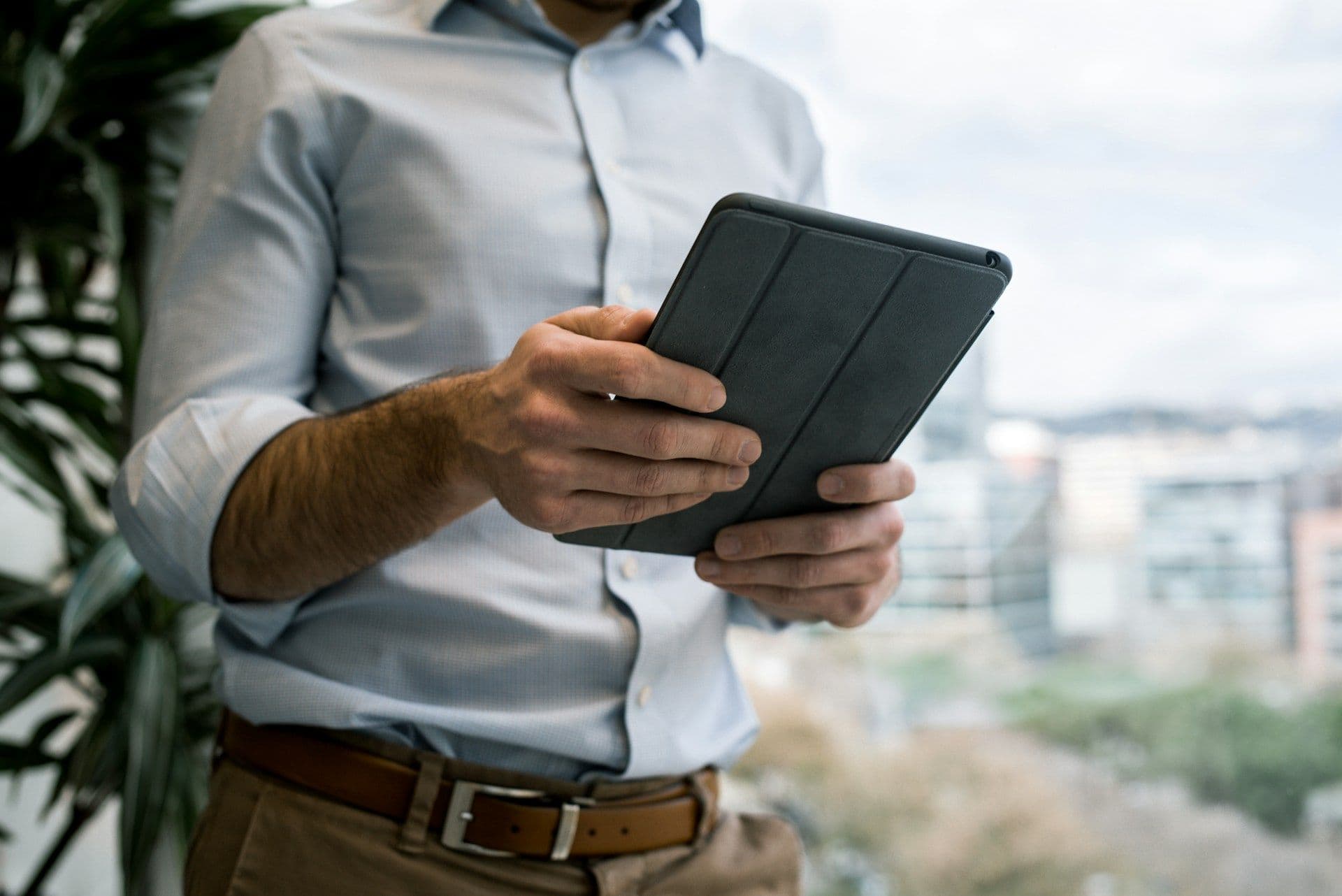 Accountant reviewing reports on a tablet in a modern office