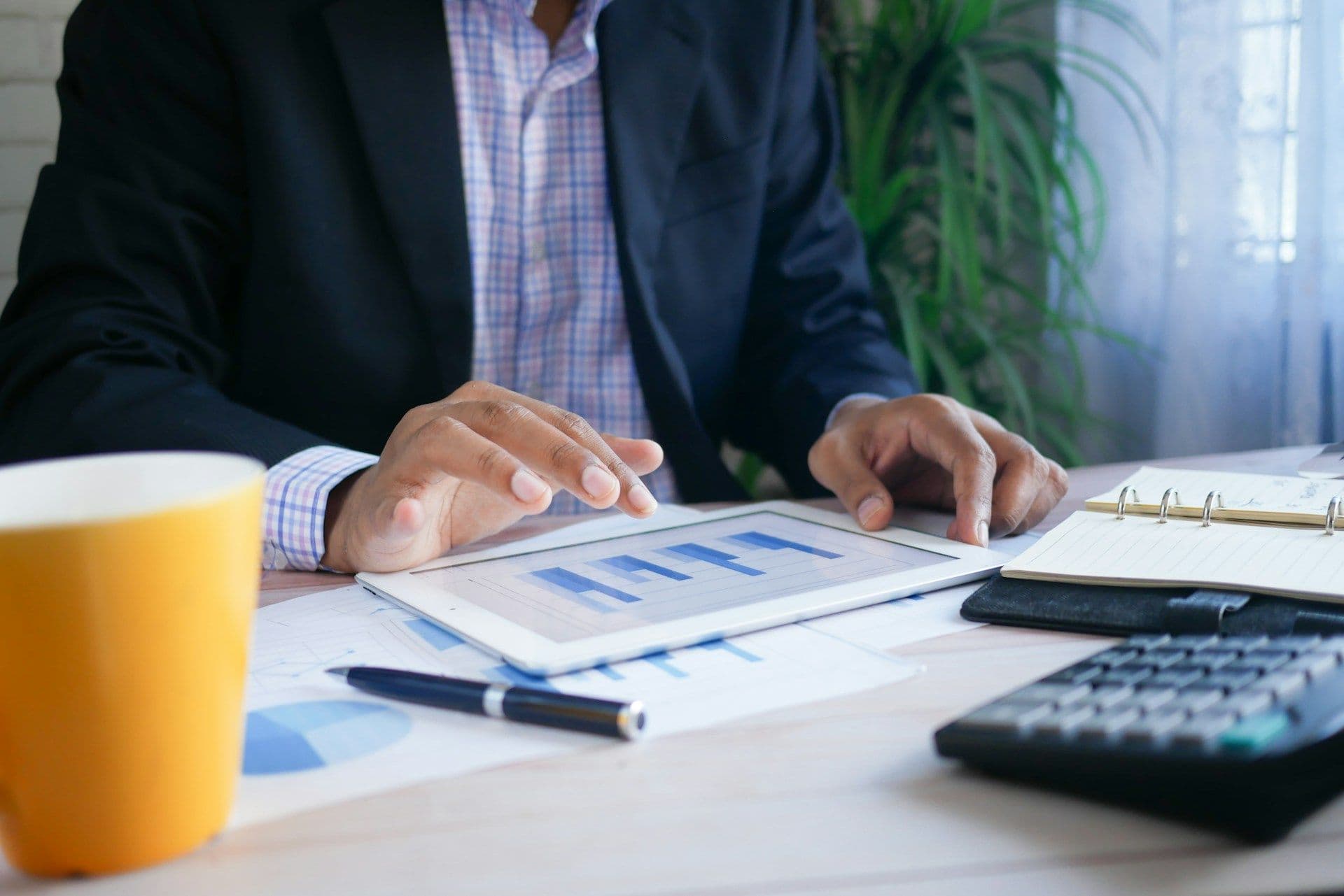 Business owner reviewing company finances on a tablet
